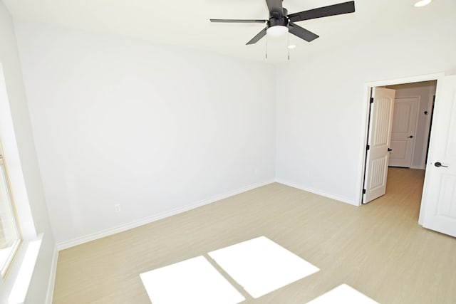 unfurnished room featuring ceiling fan and light hardwood / wood-style flooring