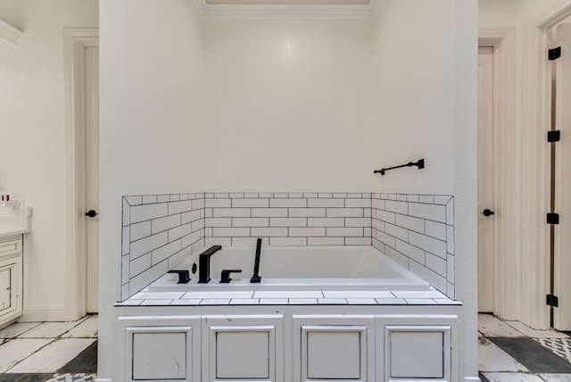 bathroom with a bathing tub, vanity, and ornamental molding