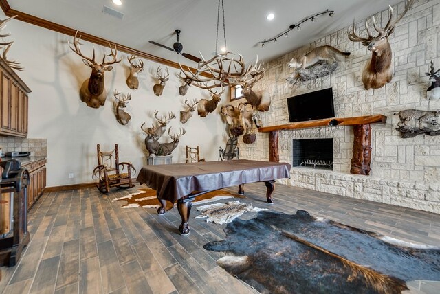 rec room with a fireplace, dark hardwood / wood-style flooring, crown molding, and pool table