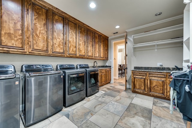 washroom featuring crown molding, sink, cabinets, and independent washer and dryer