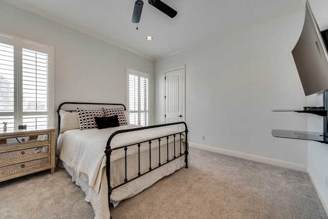 bedroom featuring ceiling fan, light carpet, and multiple windows