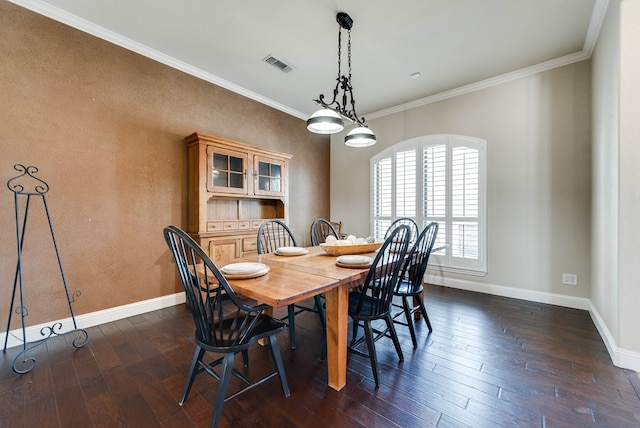 dining room featuring crown molding and dark wood-type flooring