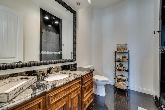 bathroom featuring toilet, vanity, tile patterned floors, and walk in shower