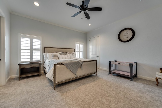 carpeted bedroom featuring ceiling fan and crown molding