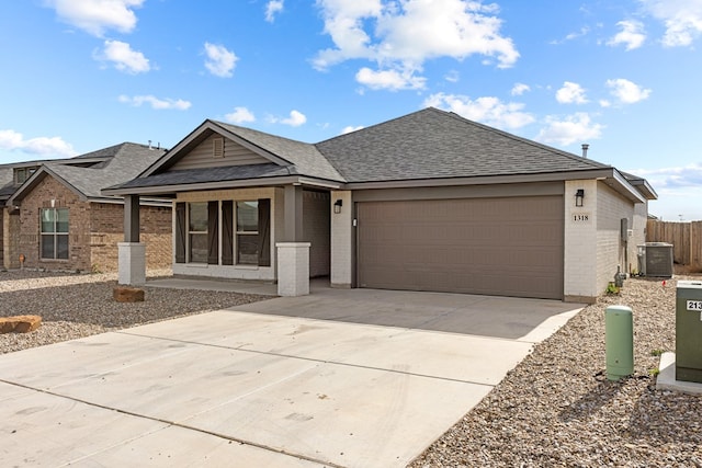 view of front of home with central AC unit and a garage