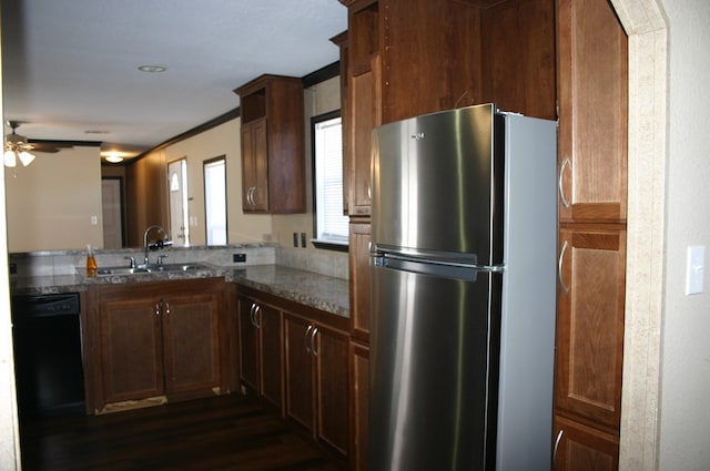 kitchen featuring stainless steel fridge, ceiling fan, dark wood-type flooring, sink, and black dishwasher