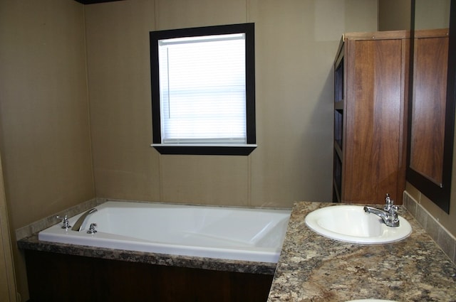 bathroom with a bathing tub and vanity