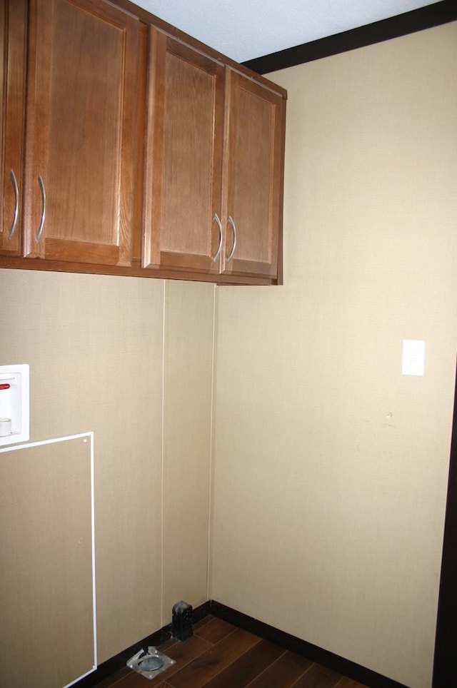 laundry area with cabinets, washer hookup, and dark hardwood / wood-style floors