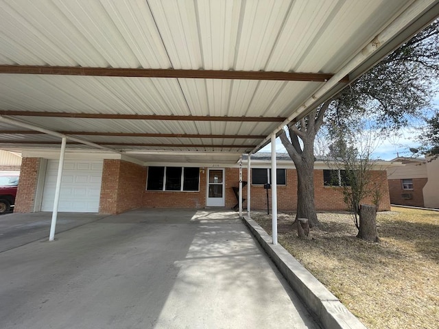 view of patio / terrace with a carport and a garage