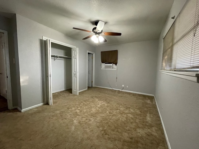 unfurnished bedroom with ceiling fan, a textured ceiling, carpet flooring, baseboards, and a closet