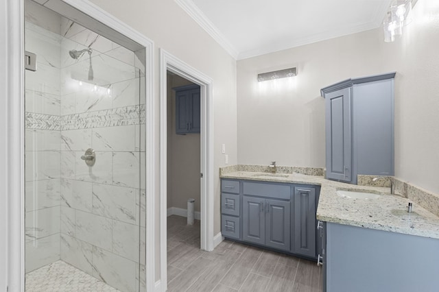 bathroom with tiled shower, vanity, and ornamental molding