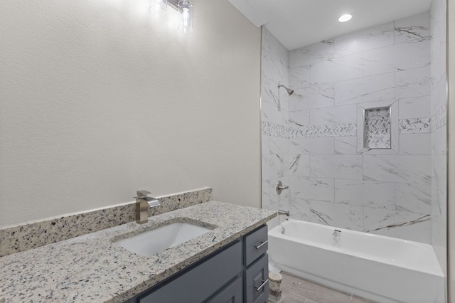 bathroom with vanity, wood-type flooring, and tiled shower / bath