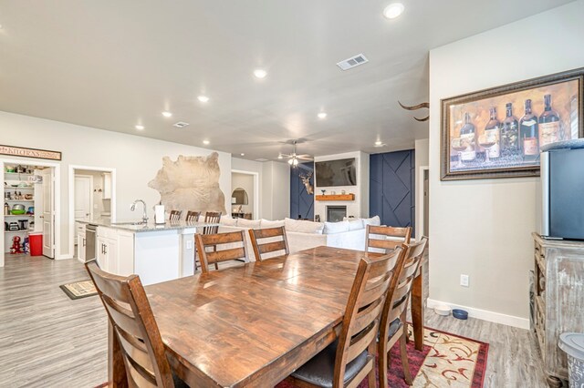 dining room featuring light hardwood / wood-style flooring and sink