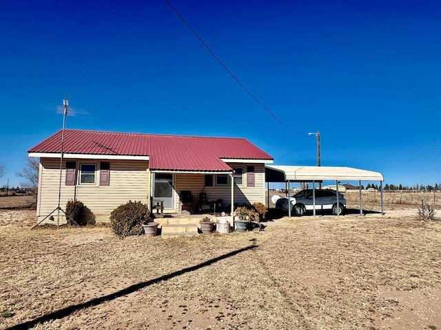 rear view of house with a carport and metal roof