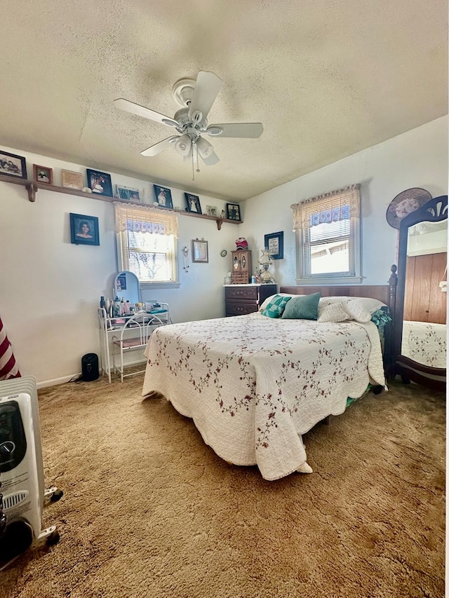 bedroom with a textured ceiling, ceiling fan, and carpet flooring