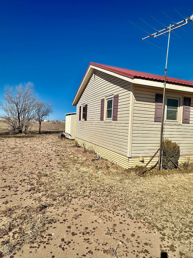 view of property exterior with metal roof