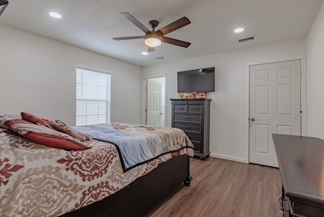 bedroom featuring ceiling fan and light hardwood / wood-style flooring