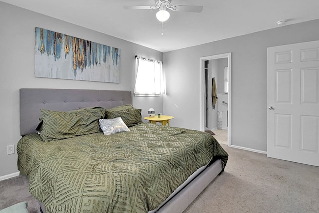 carpeted bedroom featuring ensuite bathroom and ceiling fan