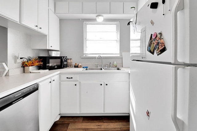 kitchen featuring white cabinetry, sink, dishwasher, and white fridge