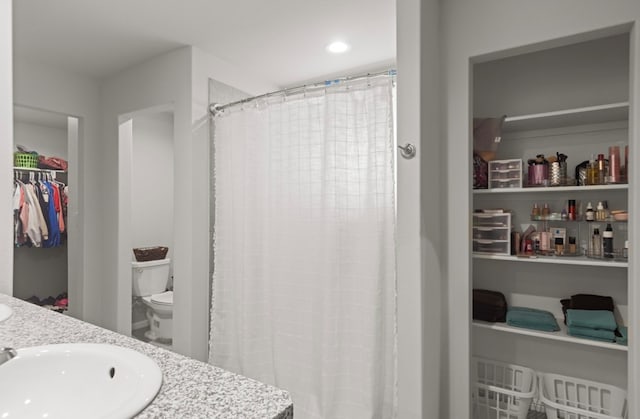 bathroom featuring vanity and toilet