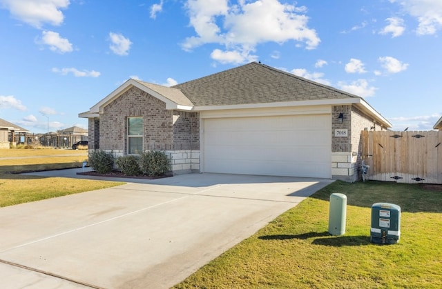 single story home featuring a garage and a front lawn