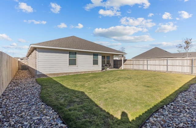 back of house featuring a yard and central AC unit