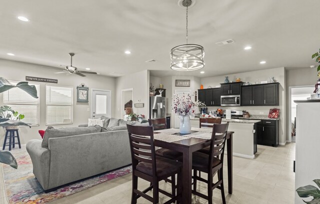 dining room featuring ceiling fan with notable chandelier