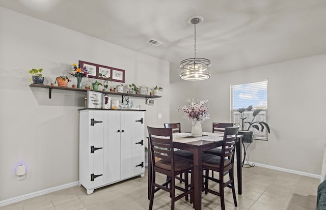 tiled dining room featuring a notable chandelier