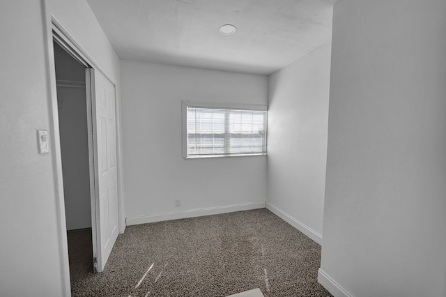 unfurnished bedroom featuring carpet and a closet