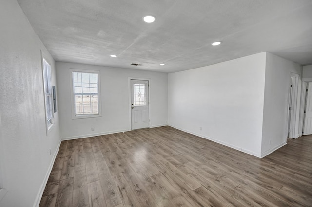 unfurnished room with light hardwood / wood-style floors