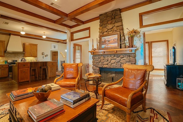 sitting room with a fireplace, dark hardwood / wood-style flooring, beamed ceiling, and sink