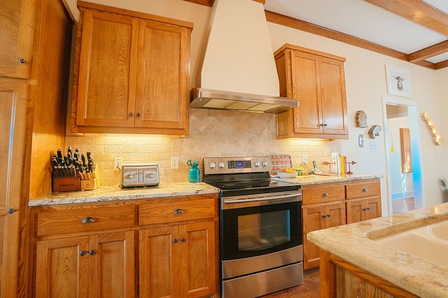 kitchen with wall chimney exhaust hood, beam ceiling, stainless steel range with electric cooktop, and tasteful backsplash