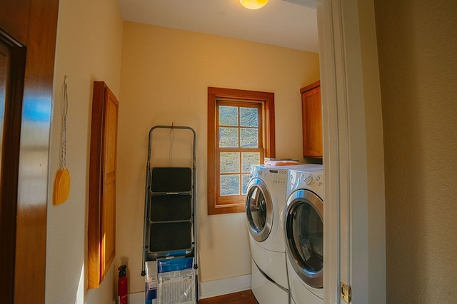 laundry area with cabinets and washer and clothes dryer