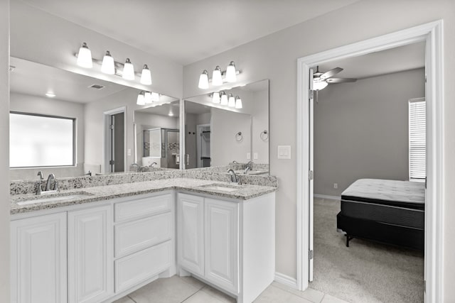 bathroom featuring vanity, a shower with door, tile patterned floors, and ceiling fan