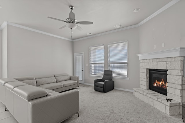 carpeted living room featuring a stone fireplace, ceiling fan, and crown molding