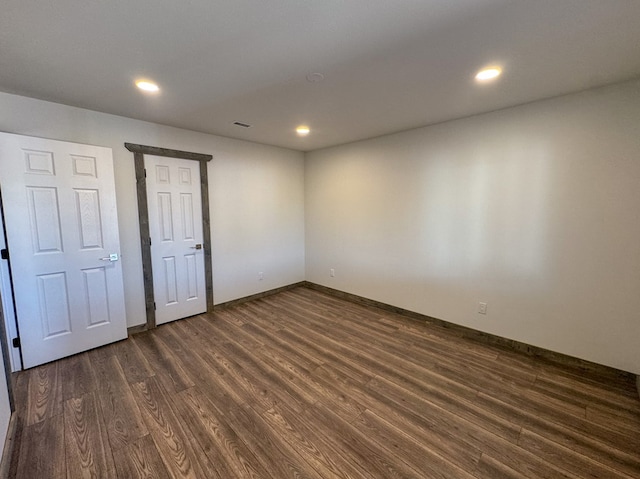 spare room featuring dark hardwood / wood-style flooring