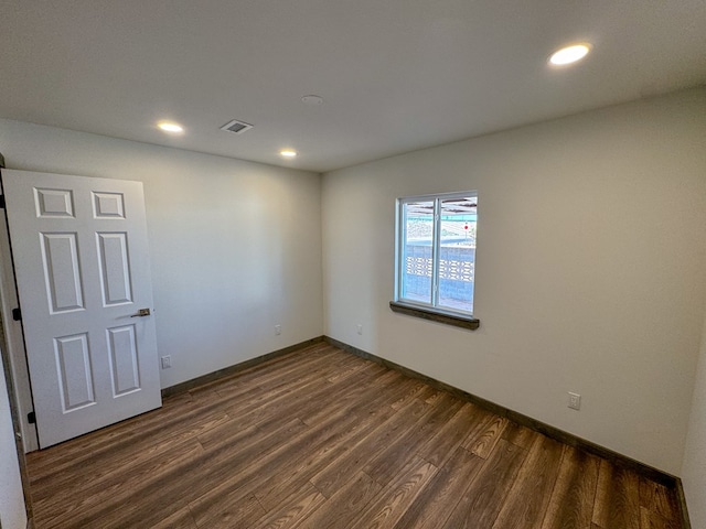 spare room featuring dark hardwood / wood-style floors