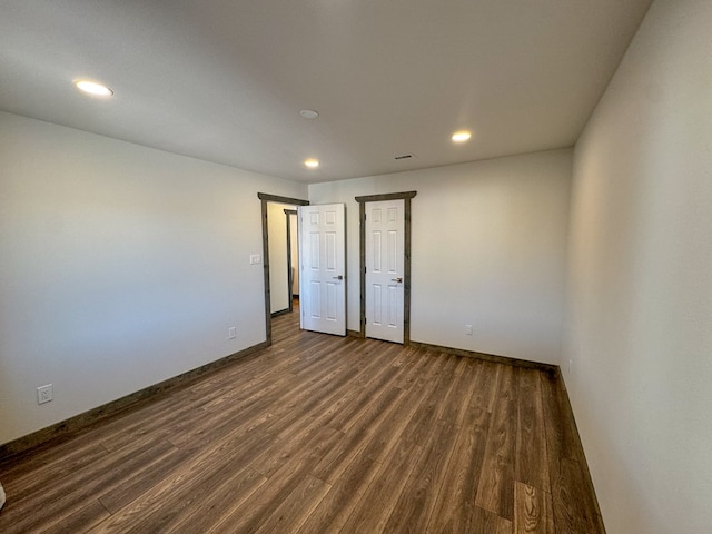 unfurnished bedroom with dark hardwood / wood-style floors