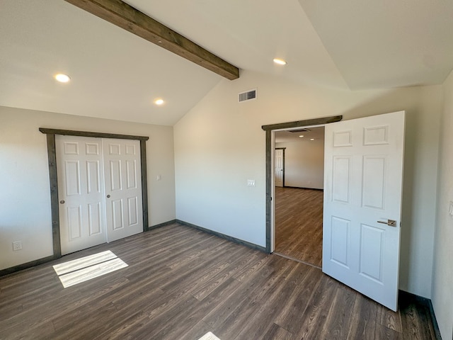 unfurnished bedroom with vaulted ceiling with beams and dark hardwood / wood-style floors