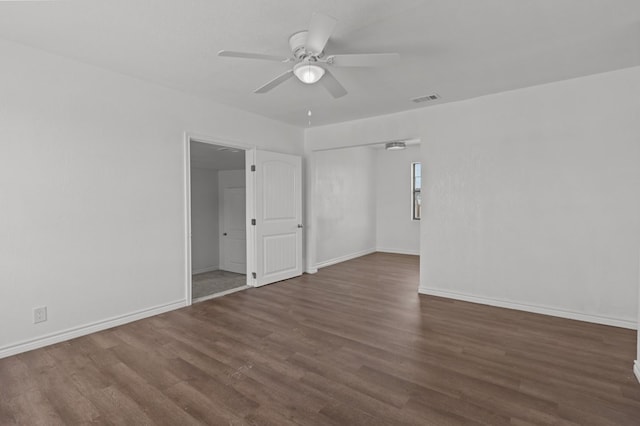 spare room with dark hardwood / wood-style floors and ceiling fan