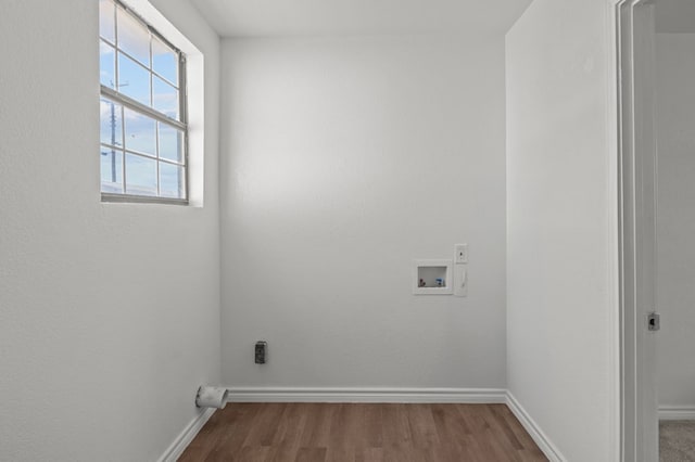 clothes washing area with wood-type flooring, electric dryer hookup, and washer hookup