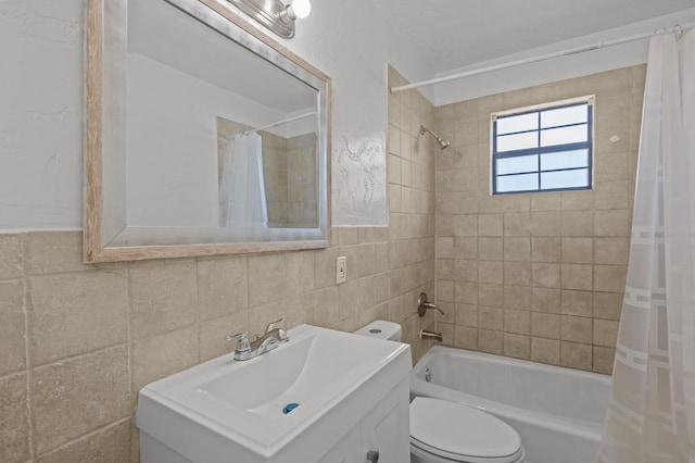 full bathroom featuring vanity, tile walls, shower / bathtub combination with curtain, and toilet