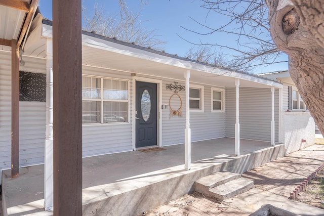 doorway to property featuring covered porch