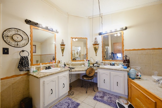 bathroom with tile patterned flooring, vanity, tile walls, and ornamental molding