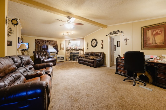 carpeted living room with ceiling fan, vaulted ceiling with beams, a textured ceiling, a fireplace, and ornamental molding