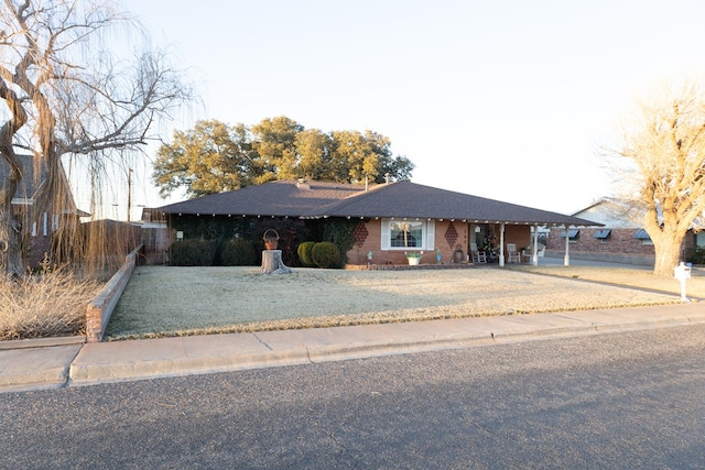 ranch-style home with a front lawn