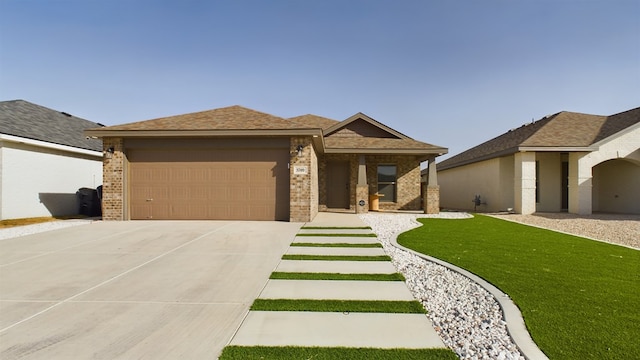 view of front of home with a garage and a front lawn