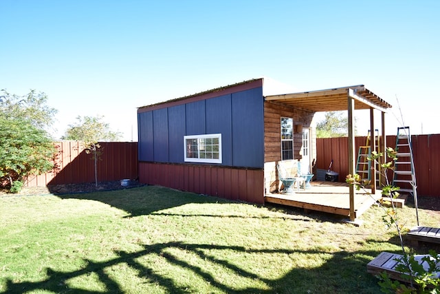 view of home's exterior with a deck and a yard