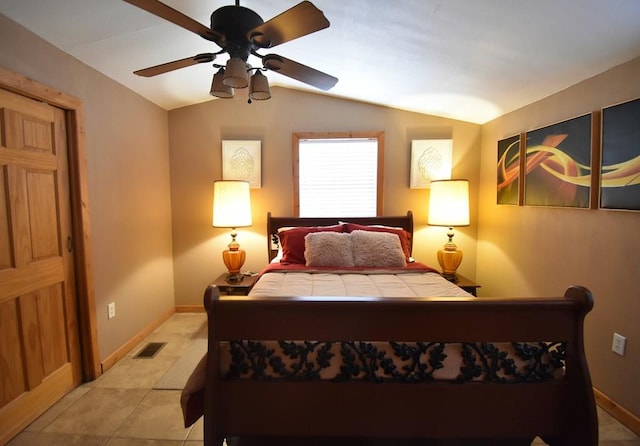 bedroom featuring ceiling fan, light tile patterned flooring, and vaulted ceiling