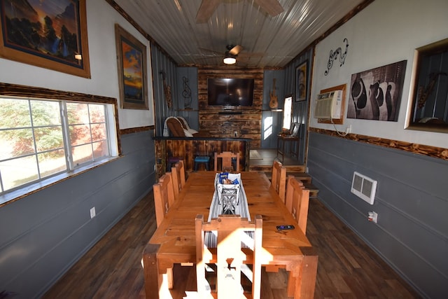 dining space featuring ornamental molding, ceiling fan, dark wood-type flooring, and wood walls